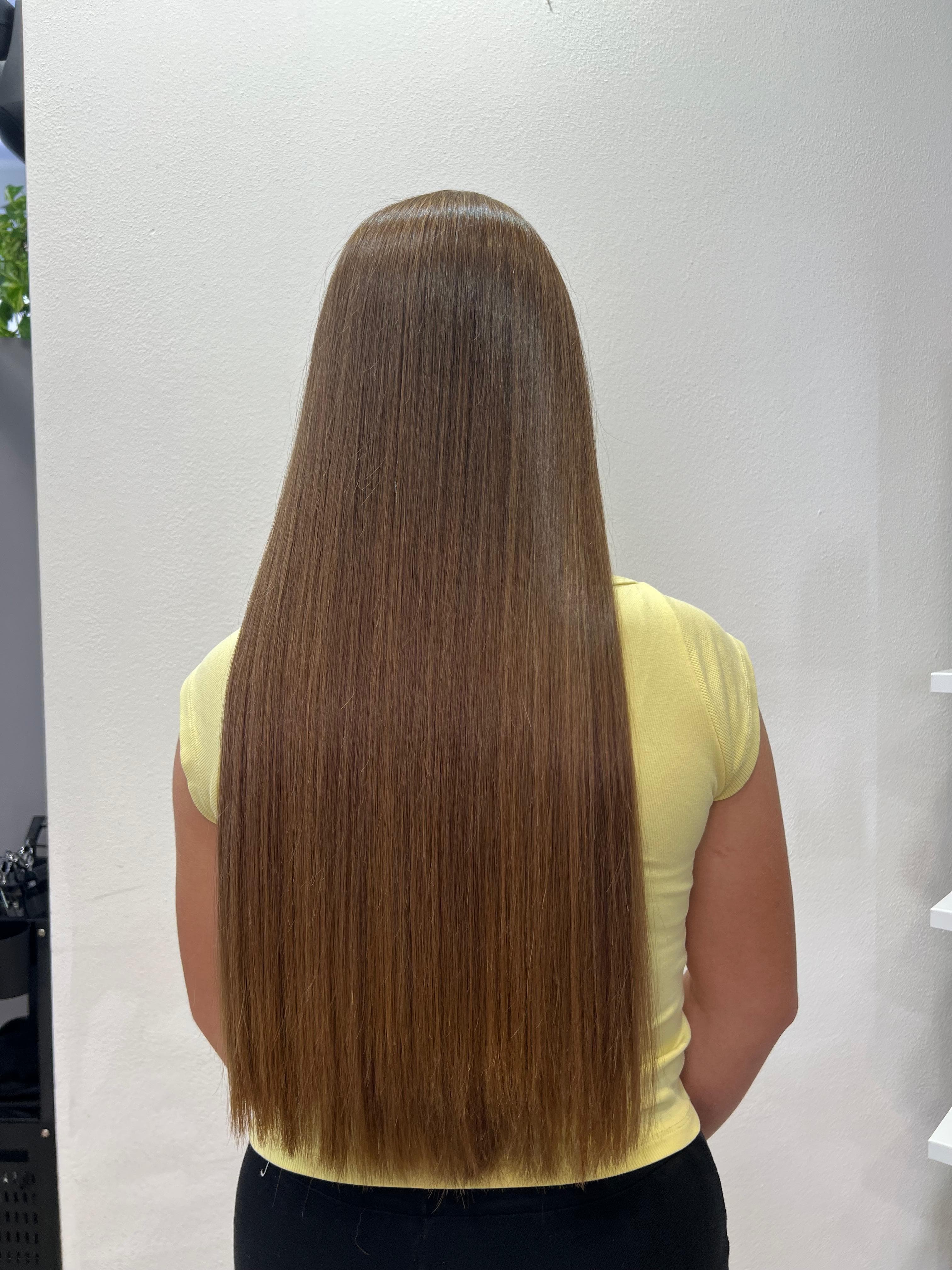 Capelli lisci e setosi con effetto specchio dopo il trattamento alla cheratina